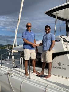 an iyer family member shaking hands with yacht broker terry singh of catamara guru following purchase of his lagoon 450