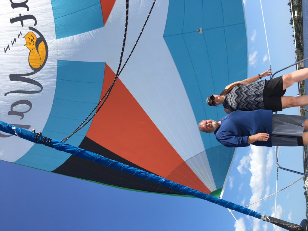 liveaboard seaschool students stand aboard captain jeff's catamaran, mira mar