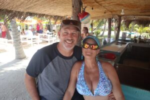 leopard 48 yacht owners jim and kat sullivan at a beach bar