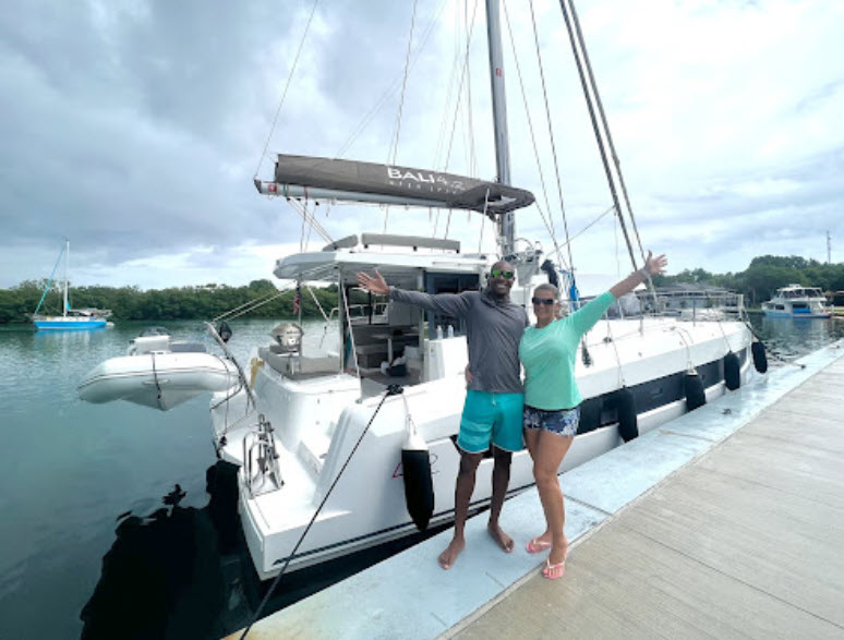 catamaran guru sailing academy students in front of the bali 4.2 they learned on